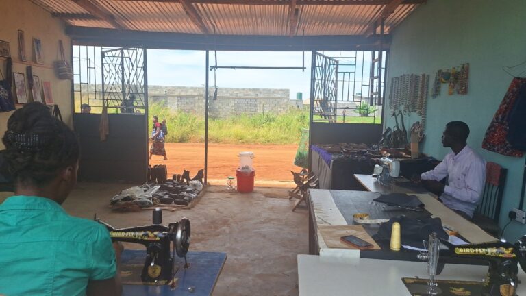 Tailoring Department at All Is Grace campus showing adults sewing, with crafts, shoes, and school uniforms as part of adult education opportunities